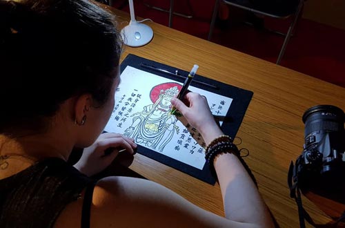 Autograf students reproducing Sutras in a Buddhist temple.